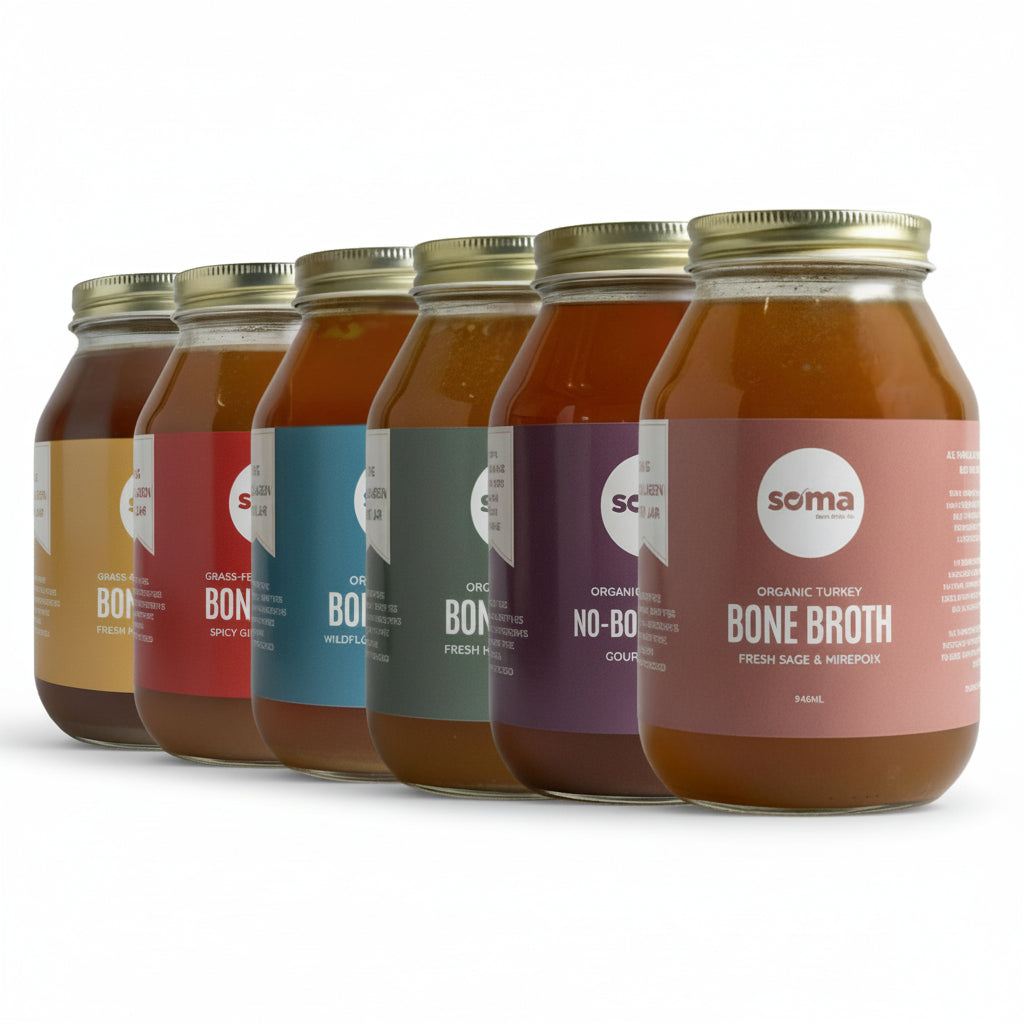 Row of jars of Soma Bone Broth with colorful labels on a white background